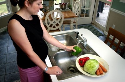 Pregnant Woman Washing Vegetables