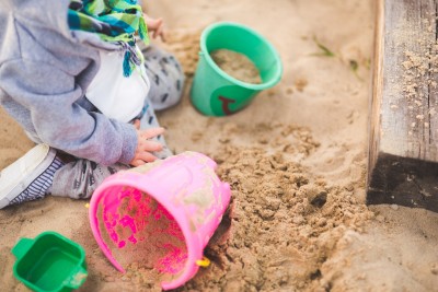 Child Playing In Sandbox Photo