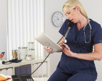 Pregnant nurse working in the office