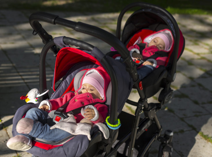 sleeping twins baby in double stroller